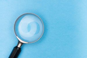 a magnifying glass icon on a blue background